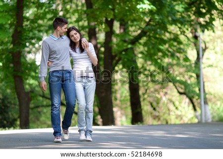 young couple taking a walk in the park