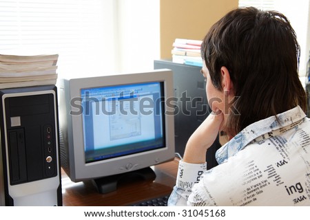 Closeup of man working on computer - face looking at monitor