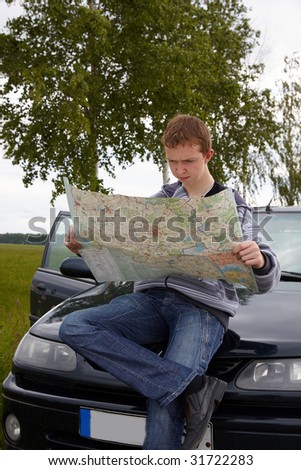 Traveling. Young driver with maps