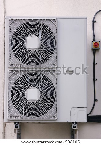 An external air conditioning exhaust unit mounted on a wall.