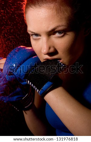 portrait of a aggressive woman boxer