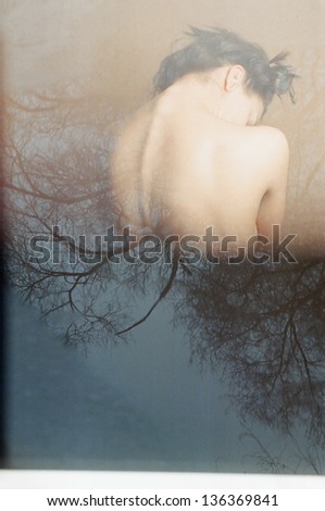 Young attractive woman dreaming spa treatment. Special patches of light and reflections. scanned film. double exposition.