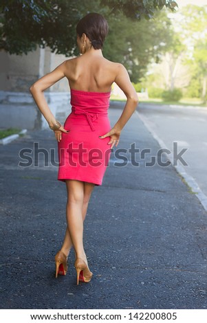 fashion urban portrait of young, slim, beautiful model  in pink dress