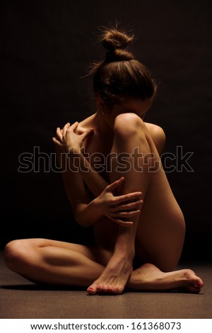 Beautiful body of young woman over dark background