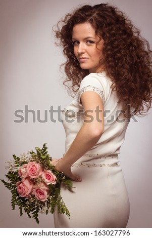 Beautiful caucasian woman with bouquet pink roses