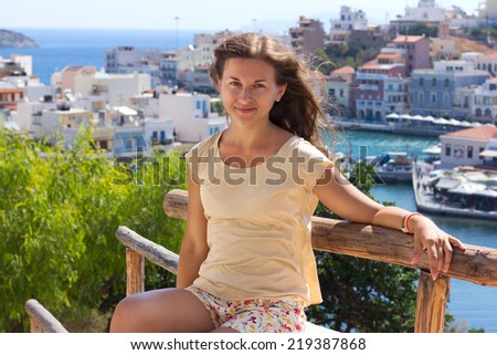 sitting woman at sea coast on Crete island, Greece
