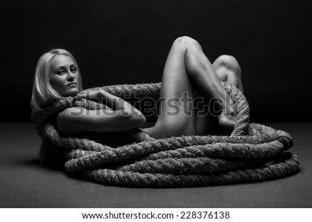 Beautiful sexy semi nude woman, dressed in rope
