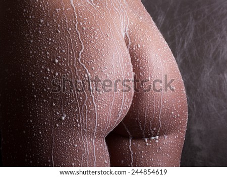 Attractive naked girl enjoys a spray with milk.Spa treatment for skin nutrition and moisturizing skin renewal.