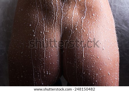 Attractive naked girl enjoys a spray with milk.Spa treatment for skin nutrition and moisturizing skin renewal.