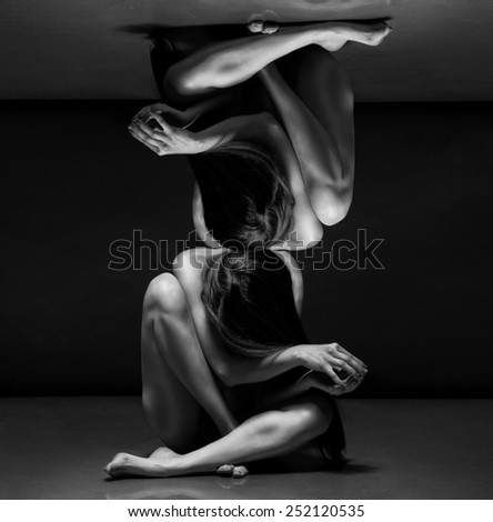 Abstract concept. Beautiful bodies of young women over dark background