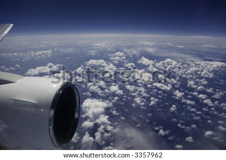 view of ocean and clouds from jet airplane window