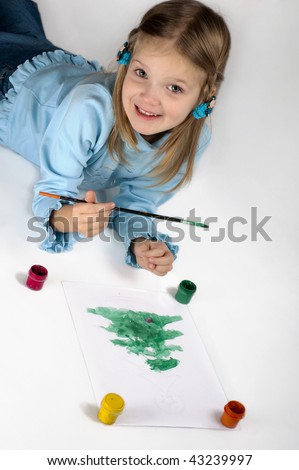 small girl painting a christmas tree