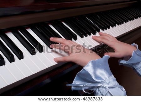 Young piano player\'s hands on the keyboard