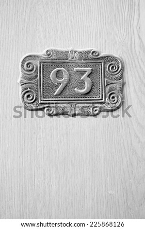 Door Number 93 on white wooden door