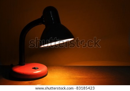 Retro lamp on empty desk. Office or education night work background.