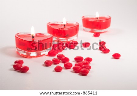 Heart-shaped gel candles with cinnamon heart candies.