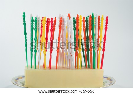 Party Forks stuck upright in a block of white cheese.