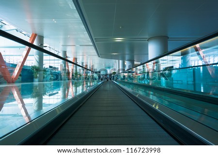 moving escalator in the modern airport terminal