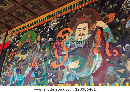 old mural painting on ancient buddhist temple wall in inner mongolia,China.buddhist four heavenly kings