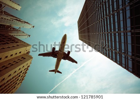airplane and modern buildings with dramatic sky,abstract cityscape