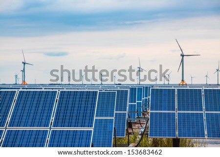 solar and wind power in coastal mud flat, clean energy complementary background.