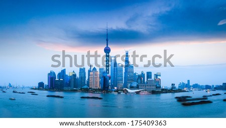 panoramic view of shanghai skyline and busy huangpu river at dusk