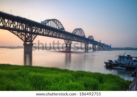 jiujiang bridge at dusk ,the river boats sailing motion blur