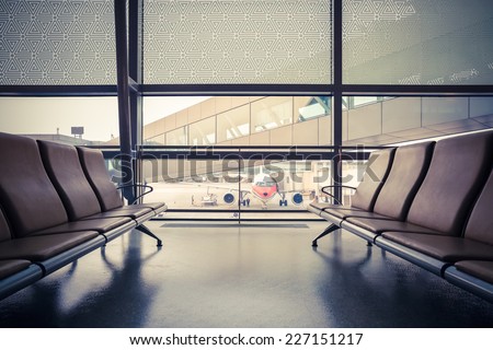 airport waiting area , seats and outside the window scene