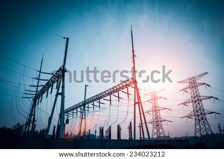 power distributing substation silhouetted against dusk sky ,electricity background