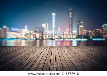 dreamlike city background of the pearl river in guangzhou at night with wooden floor as a prospect
