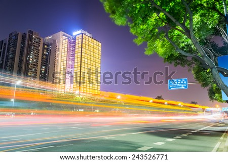 light trails on the city road in guangzhou central business district with modern buildings at night