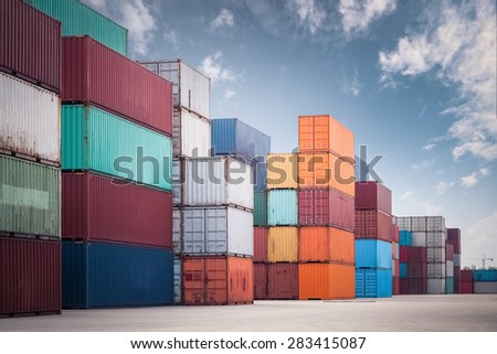 a pile of container in freight yard against a blue sky, transport background