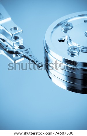 close up of the hard disk drive , read/write head on  the platters