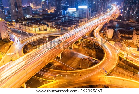 city overpass at night, circular flyover and traffic light intersection in shanghai