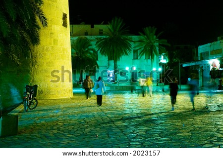 People walking in arabian medina by night