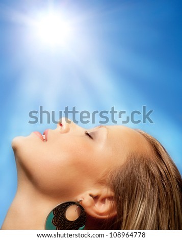 Beams of the sun and beautiful face of the girl.