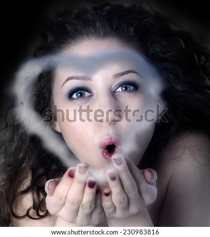 The girl sends an air-kiss in the form of a cloud in the form of heart.