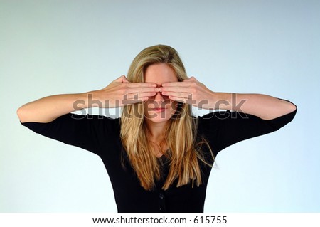 Woman with both hands over her eyes.