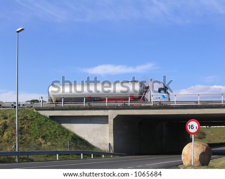 Tanker truck on the road crossing a bridge