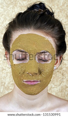 Green cosmetic mask on girls face