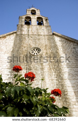 red flowers and church on the background 1