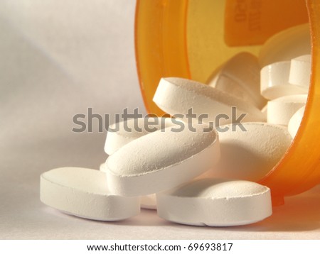 Pills poured out of a bottle.