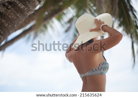 Beautiful woman posing on a paradise beach