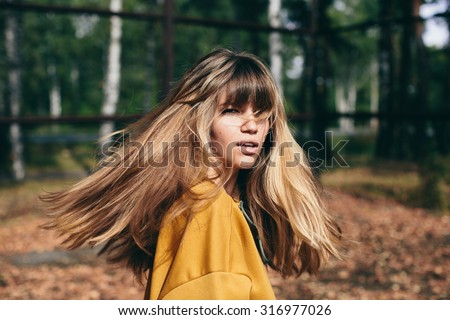 girl with beautiful hair turns around and looks at the camera
