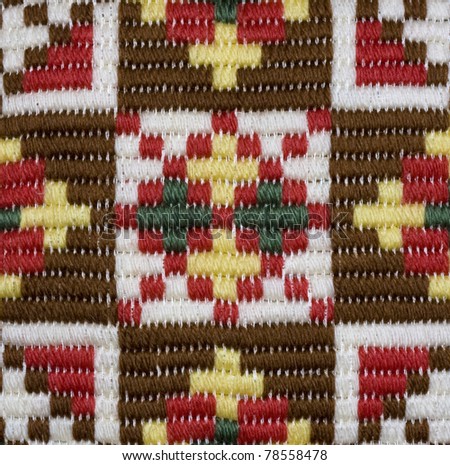 Traditional Norwegian star shaped embroidered pattern in earth tones