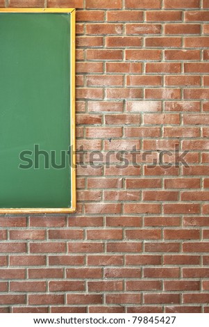 Red brick wall with a green blackboard