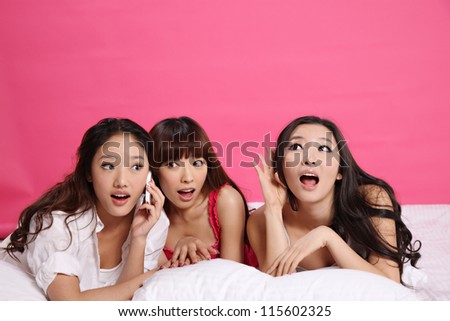 Young women on bed and isolated on pure background