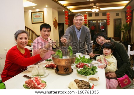 A Shot Of Chinese Family At Dinner Table