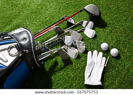 A shot of Golf glove,balls,tee and clubs in bag