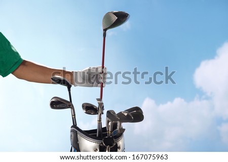 A shot of Removing golf club from a bag